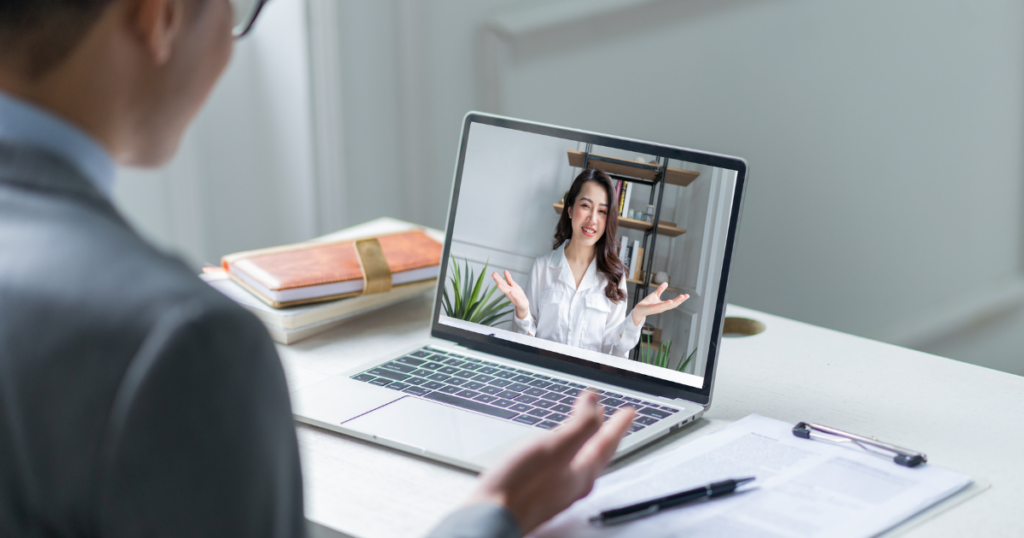 staffing agency employee talking to a woman through a laptop