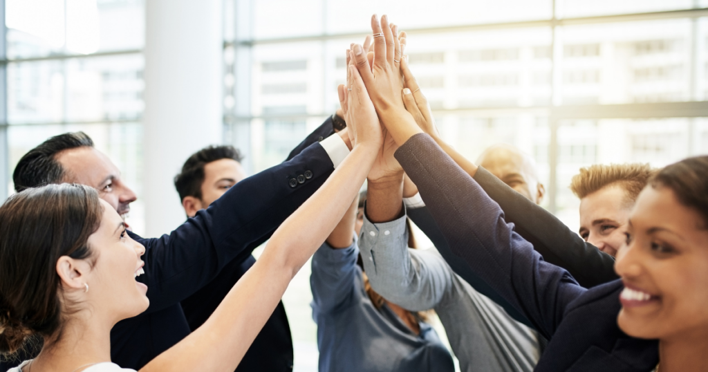 a group of people joining their hands