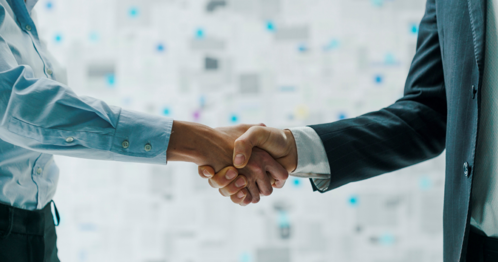 two men shaking hands to denote the partnership between a client and a staffing agency