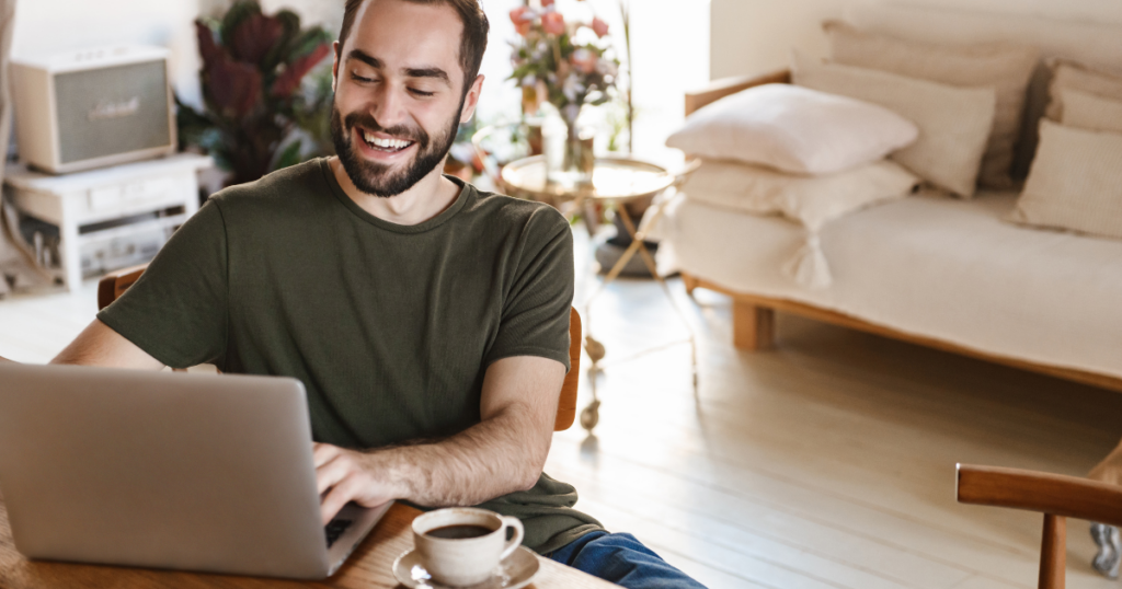 a man smiling while working remotely