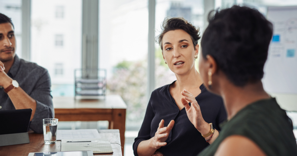 a group of people talking; a man and 2 women