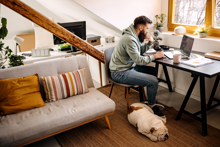 man working from home with his dog