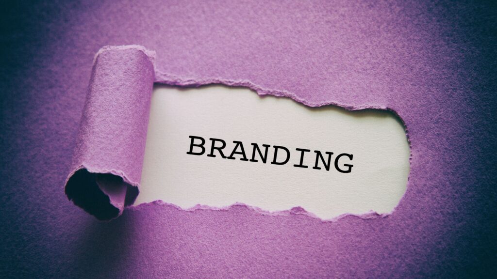 paper with torn parts revealing the words "branding"