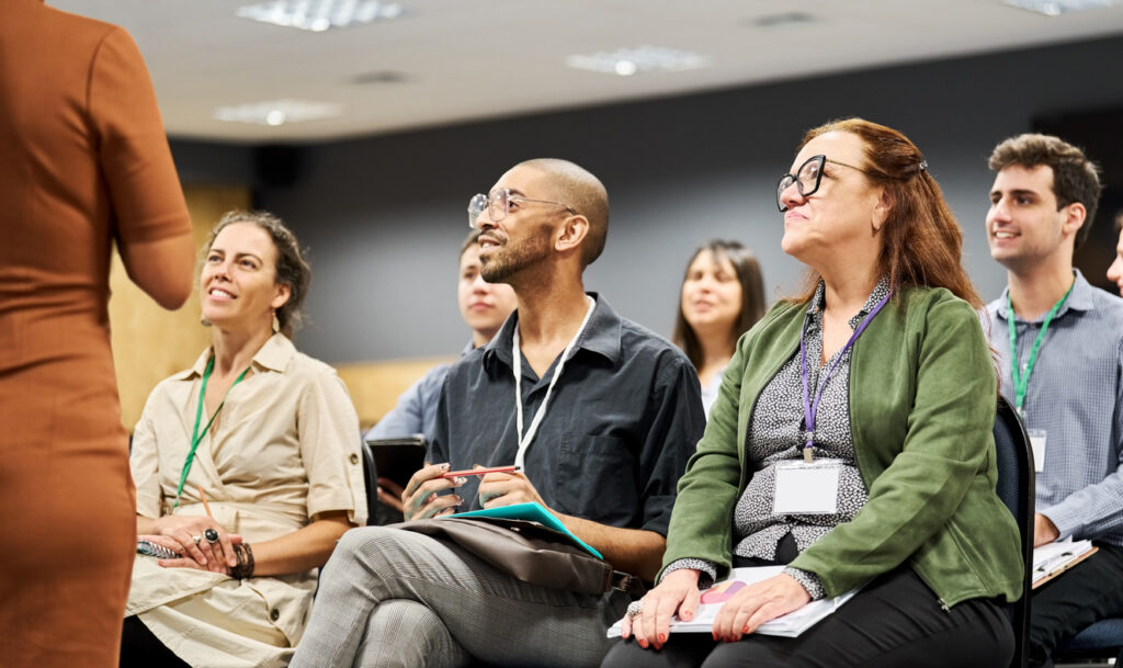 employees smiling at a woman hr manager that depicts employee engagement