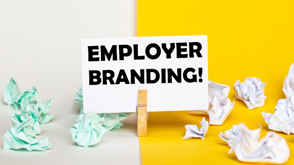 a note pad with the words "employer branding" with crumpled paper all over