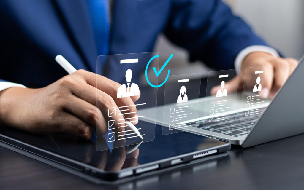 a man using a tablet and a stylus doing a reference check for new employees