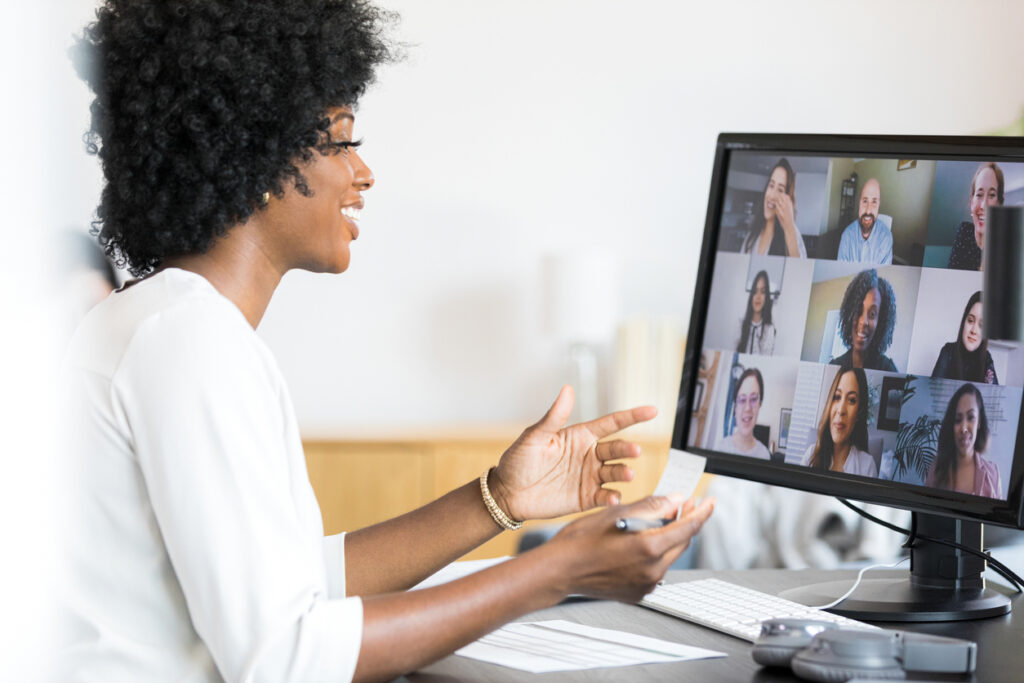 woman talking to her team with remote team communication tools like Zoom