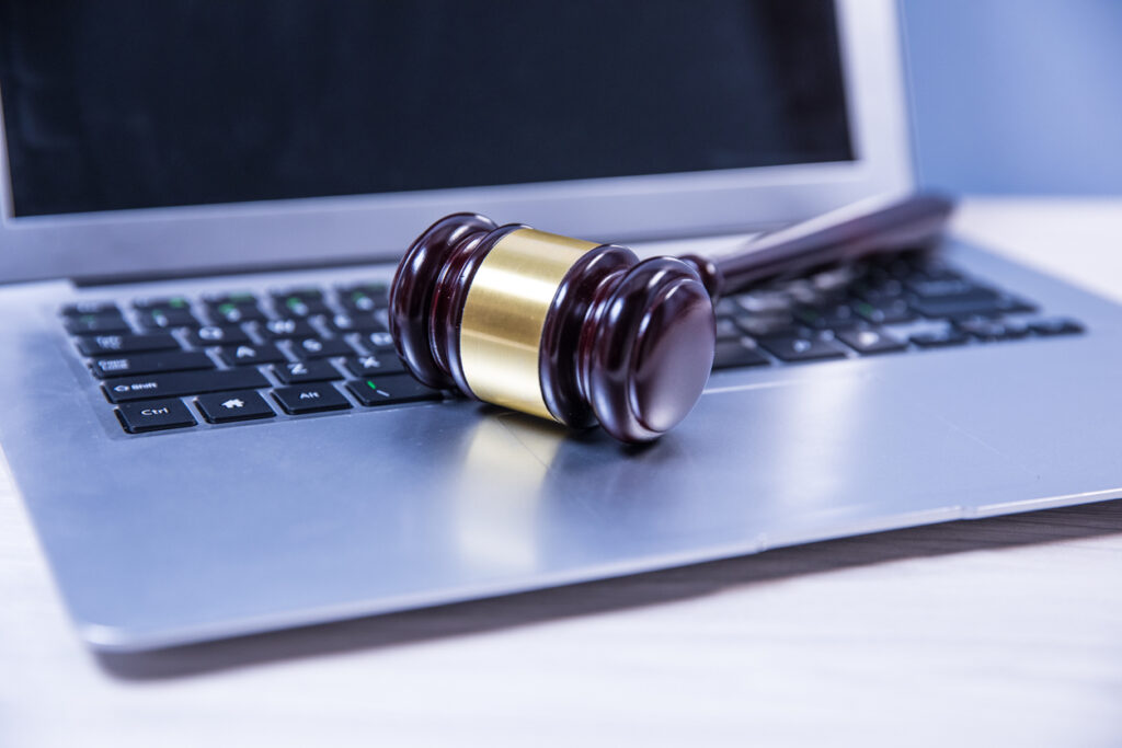 gavel on laptop keyboard to signify remote work legal considerations