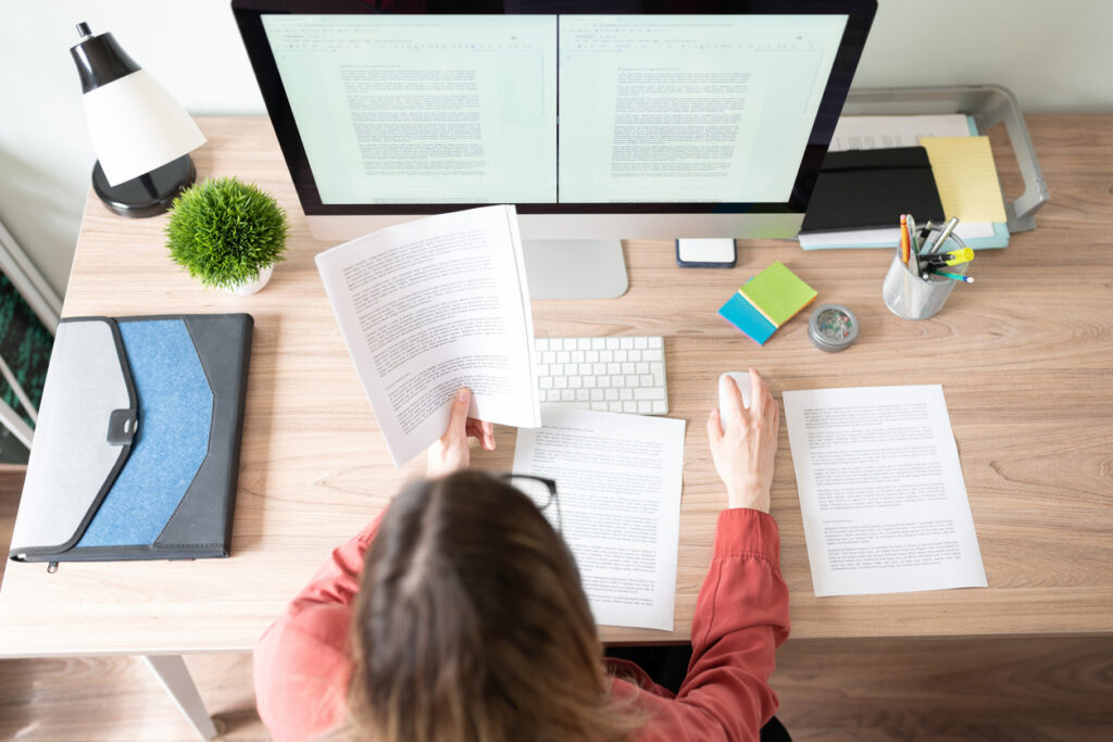 Top view of the workspace and office of a female translator that was hired from a specialized job board