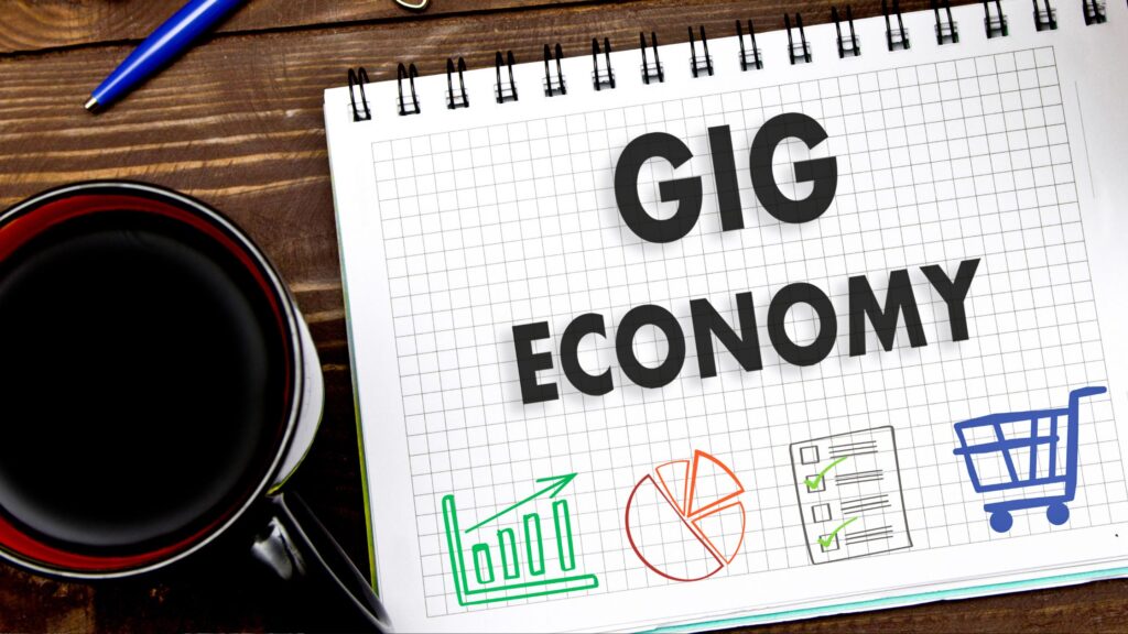 creative poster with coffee, graphing paper with GIG ECONOMY word on it and economy icons