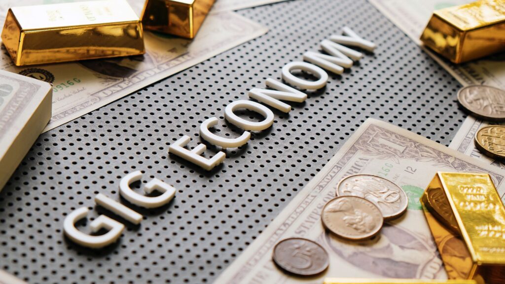 gig economy words with gold and money around it