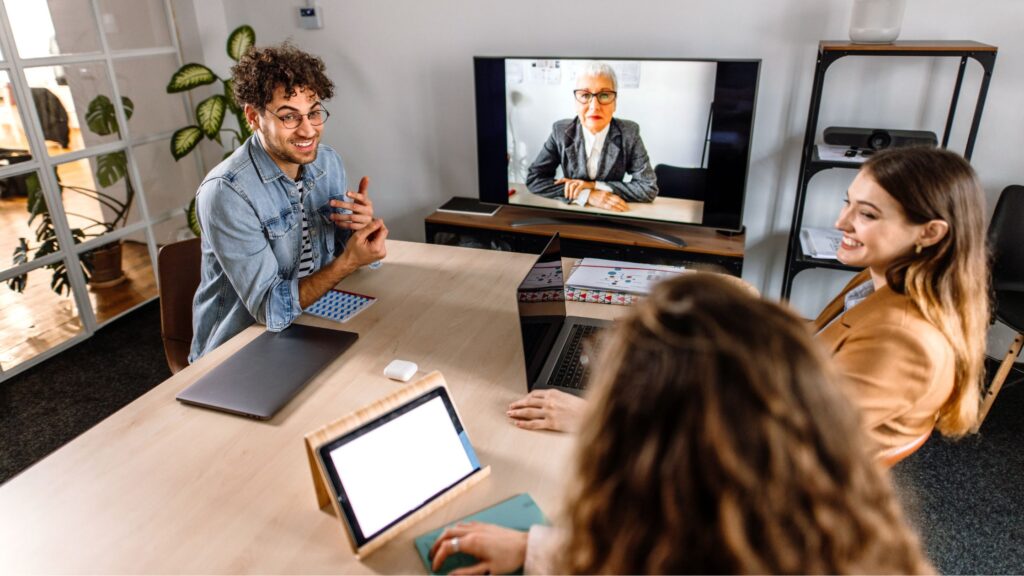 a man and 2 women having a virtual meeting with a woman