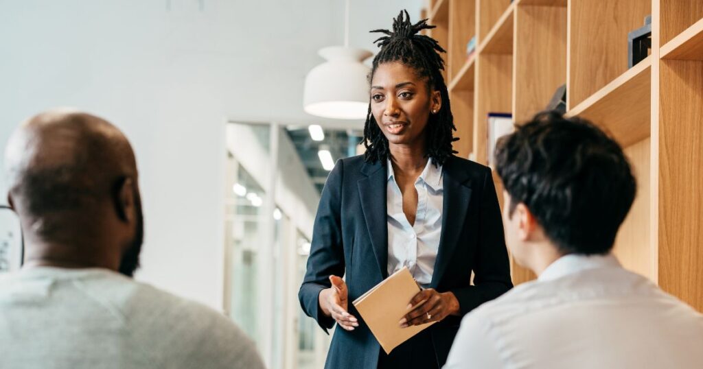 a woman setting clear goals and expectations to two men