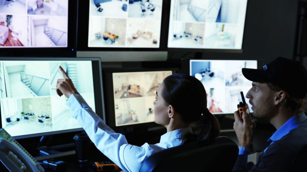 a man and a woman pointing something through a screen