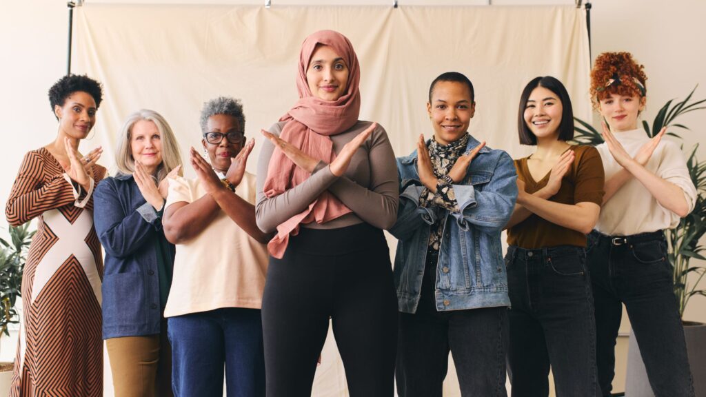 diverse women doing an "x" sign using their hands to depict unconscious bias